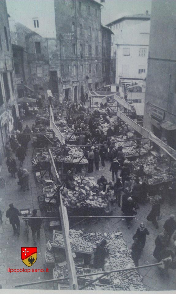 IL mercato di piazza Sant'Omobono con i banchi della frutta,verdura e alimentari allineati uno accanto all'altro - immagine tratta da . Pisa per immagini a cura di Giovanni Nardi - Pacini editore ( Camera di Commercio di Pisa ) 